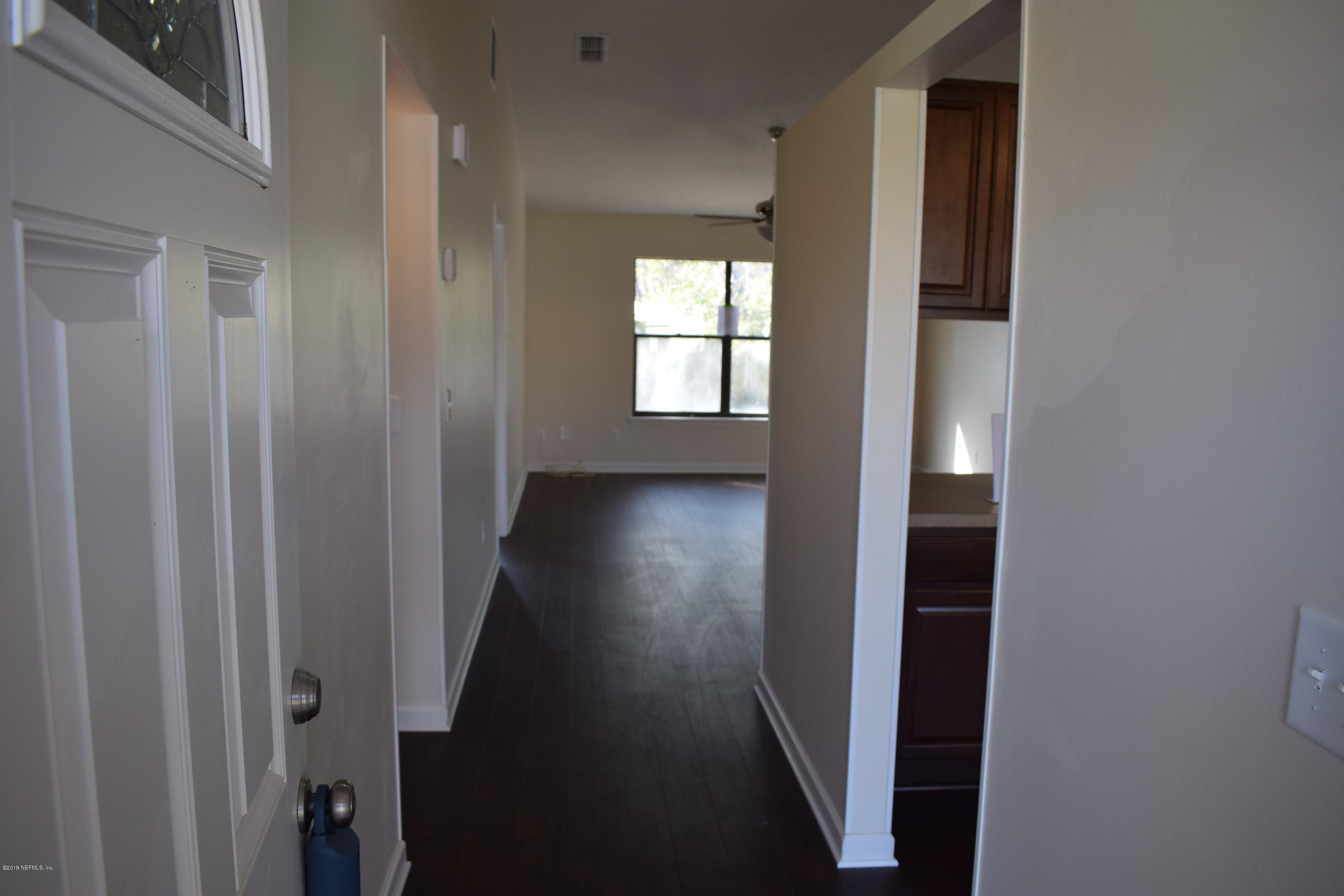3422 Ricky Court Jacksonville, FL 32223 - Photo 5 of 10 a view of a hallway with wooden floor