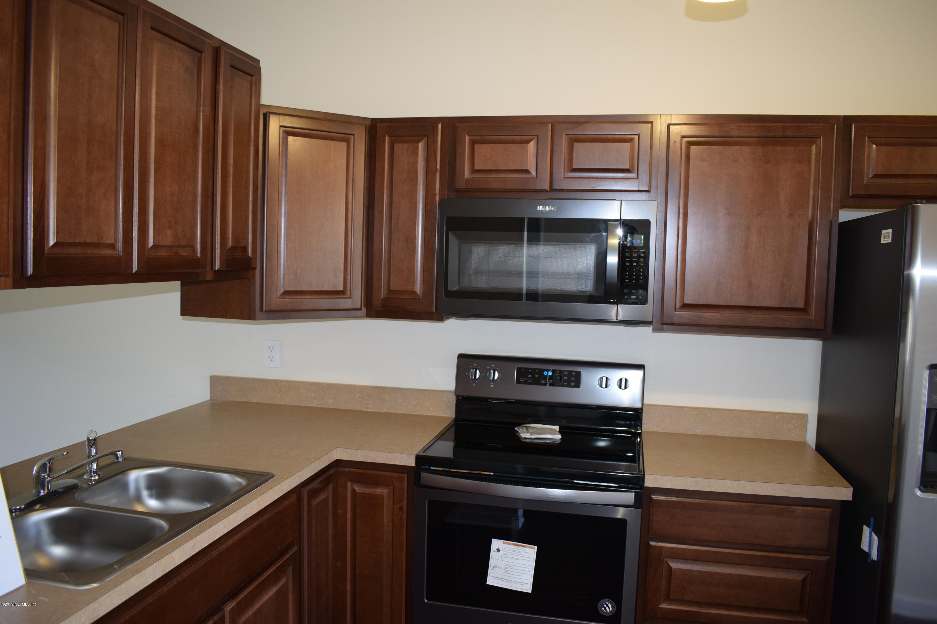 3422 Ricky Court Jacksonville, FL 32223 - Photo 8 of 10 a kitchen with a sink stove and microwave