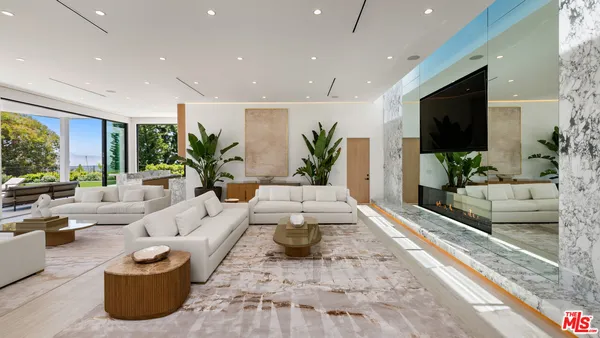a living room with furniture and large windows