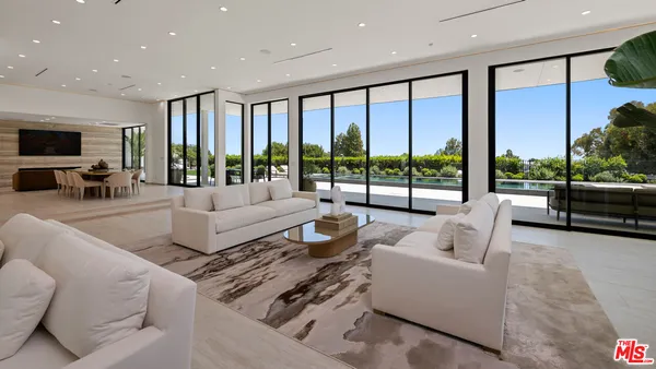 a living room with furniture large window and flat screen tv