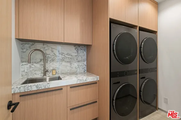 a view of a patio with a table and chairs under an umbrella