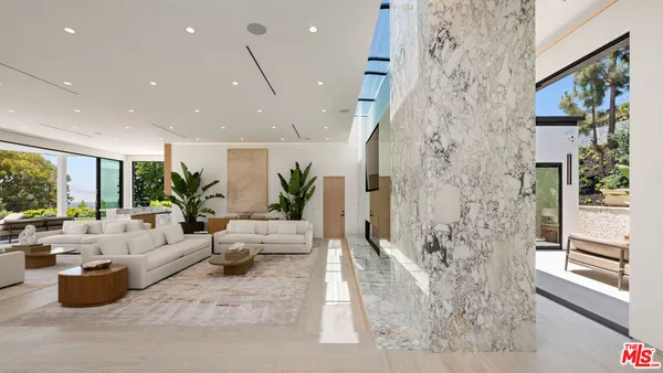 a lobby with furniture and garden view