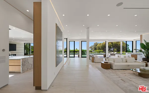 a living room with furniture and large windows
