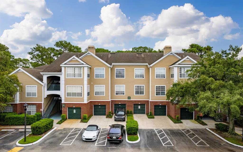 Undisclosed Address Orlando, FL 32821 - Photo 1 of 23 a front view of a house with garden and houses