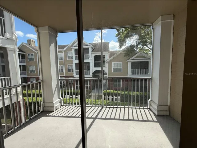 a view of a brick house with large windows and a table