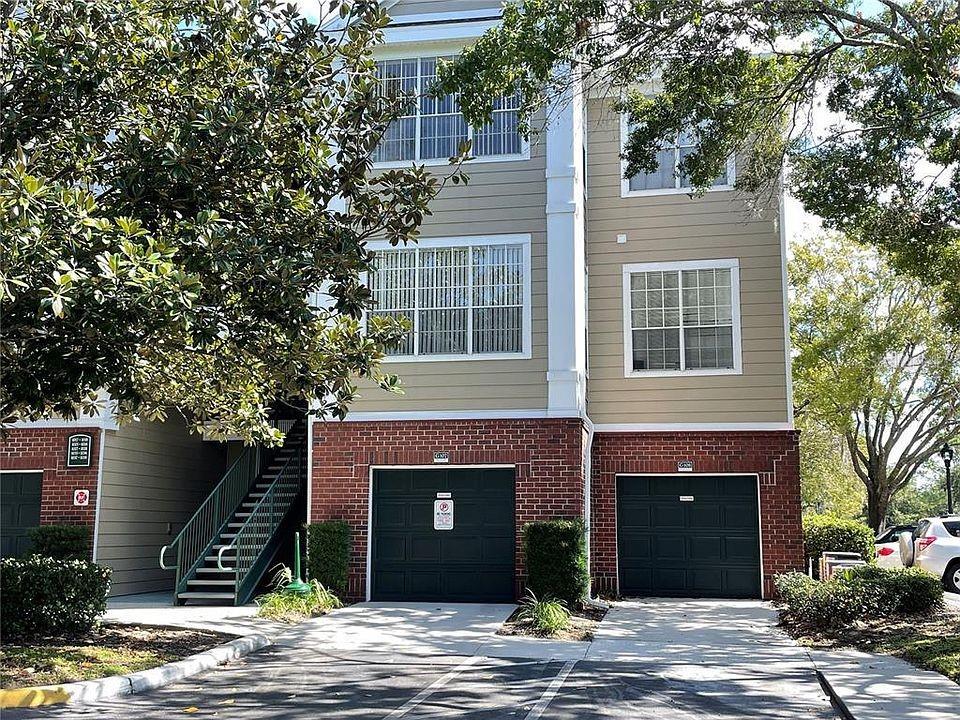 Undisclosed Address Orlando, FL 32821 - Photo 17 of 23 a front view of a house with a tree