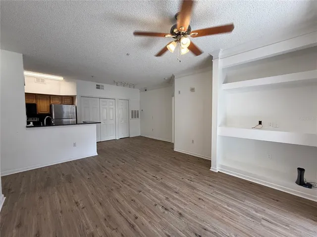 a view of a kitchen with a microwave and a ceiling fan