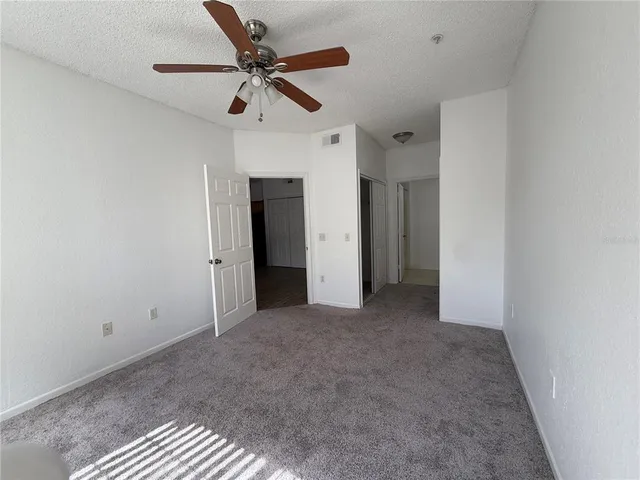 a view of a livingroom with a ceiling fan and window