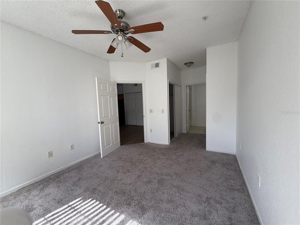 Undisclosed Address Orlando, FL 32821 - Photo 4 of 23 a view of a livingroom with a ceiling fan and window