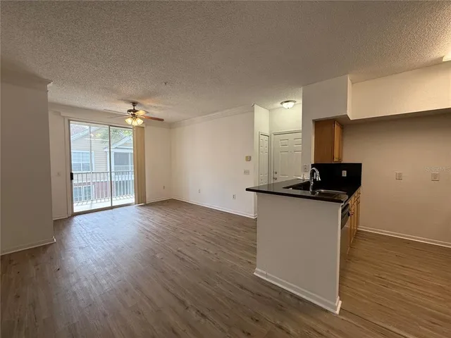 a view of a kitchen with wooden floor and a sink