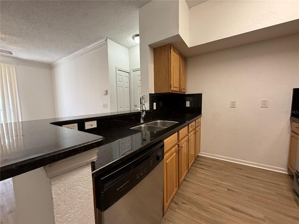 Undisclosed Address Orlando, FL 32821 - Photo 7 of 23 a kitchen with granite countertop a sink and a stove top oven
