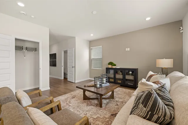 a living room with furniture and wooden floor