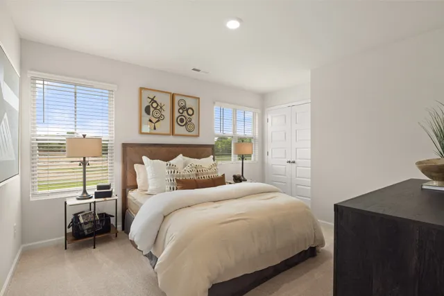 a bedroom with a bed and a dresser