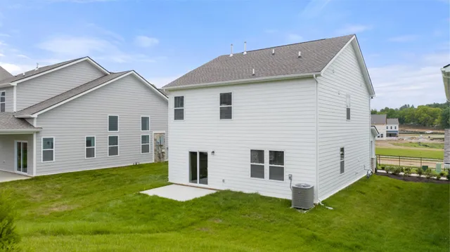 a view of a house with a yard and a house