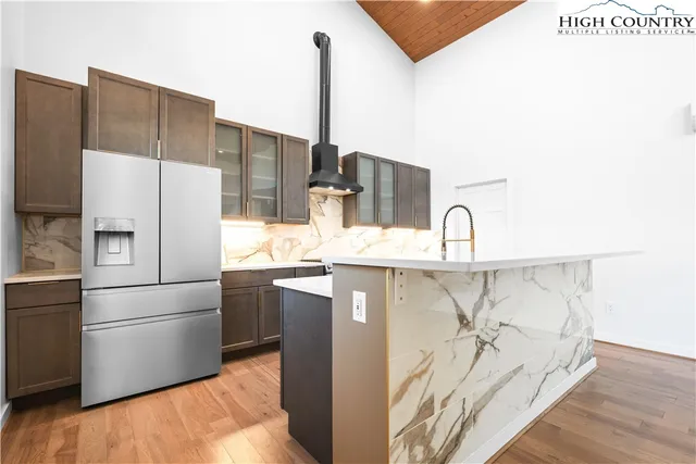 a kitchen with stainless steel appliances a refrigerator sink and cabinets