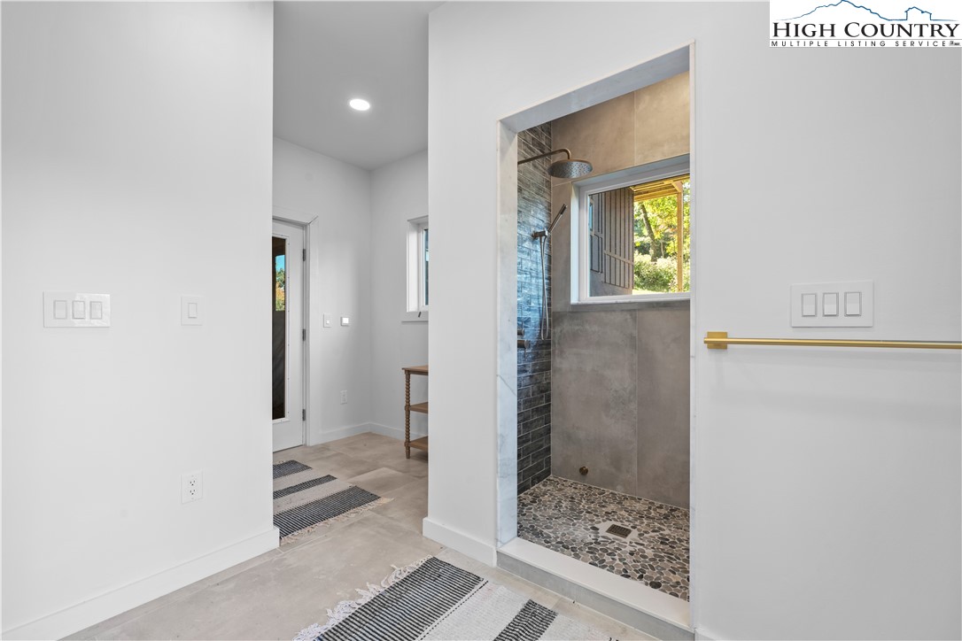 1075 Center Ct Drive Boone, NC 28607 - Photo 38 of 48 a bathroom with a glass shower door and a glass door