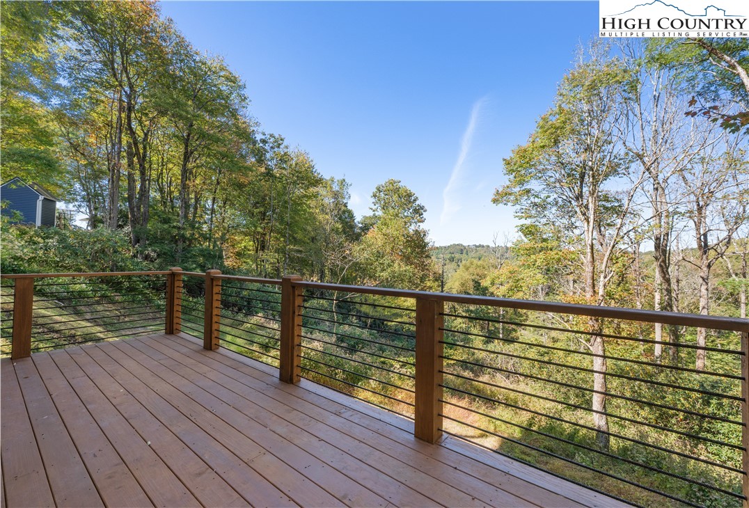 1075 Center Ct Drive Boone, NC 28607 - Photo 41 of 48 a view of a balcony with wooden floor next to a yard