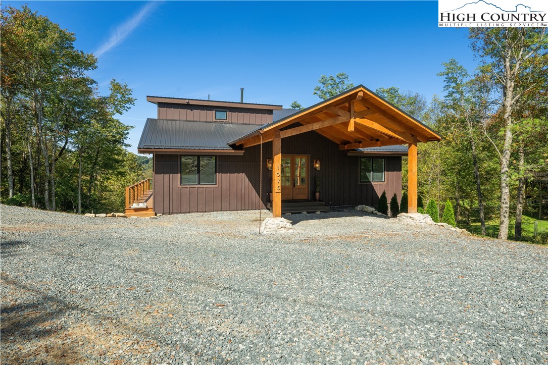 1075 Center Ct Drive Boone, NC 28607 - Photo 44 of 48 a front view of a house with a yard and garage
