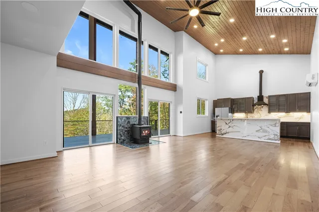 a living room with furniture and a floor to ceiling window