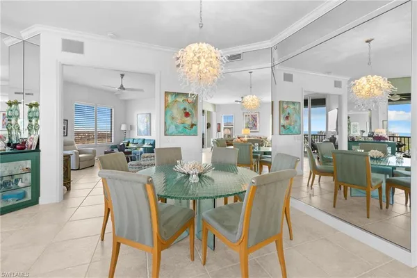 a view of a dining room with furniture and chandelier