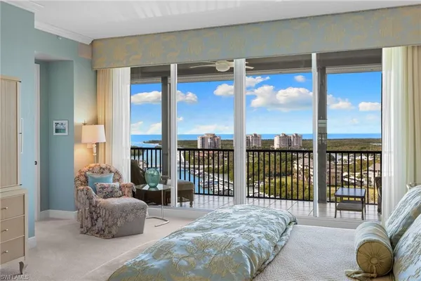 a bedroom with a bed and glass window