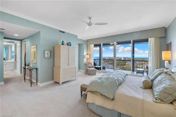 a bedroom with furniture and a large window