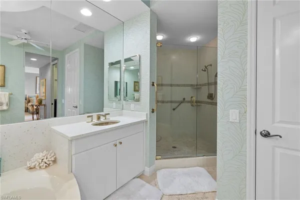 a bathroom with a sink a shower and a mirror