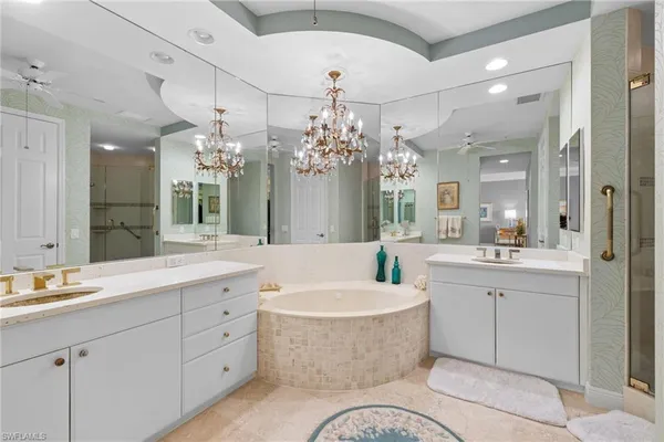 a spacious bathroom with a bathtub sink and a mirror