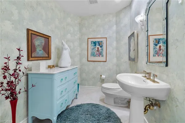 a bathroom with a sink toilet and a mirror
