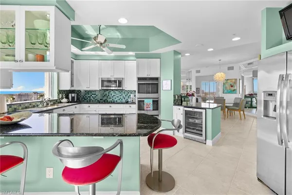 a kitchen with stainless steel appliances granite countertop a stove a sink and a wooden cabinets