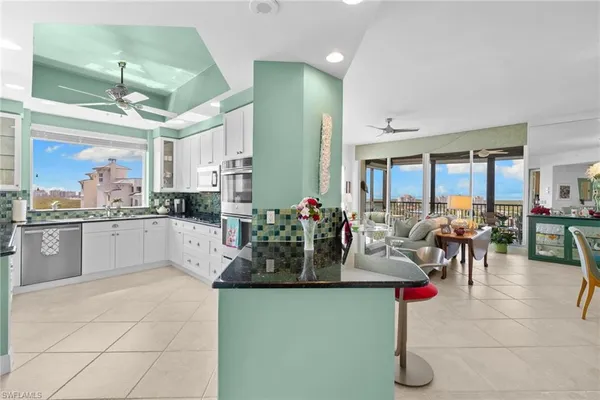 a kitchen with counter top space and dining table