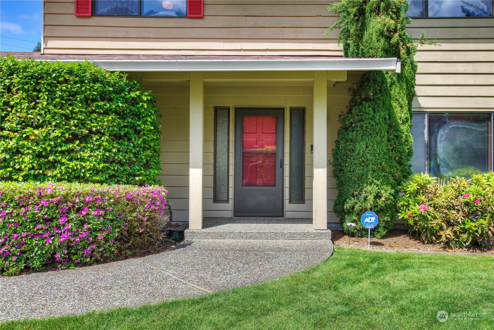 9503 127th Place Southeast Renton, WA 98056 - Photo 3 of 32 a view of a house with potted plants and a fountain