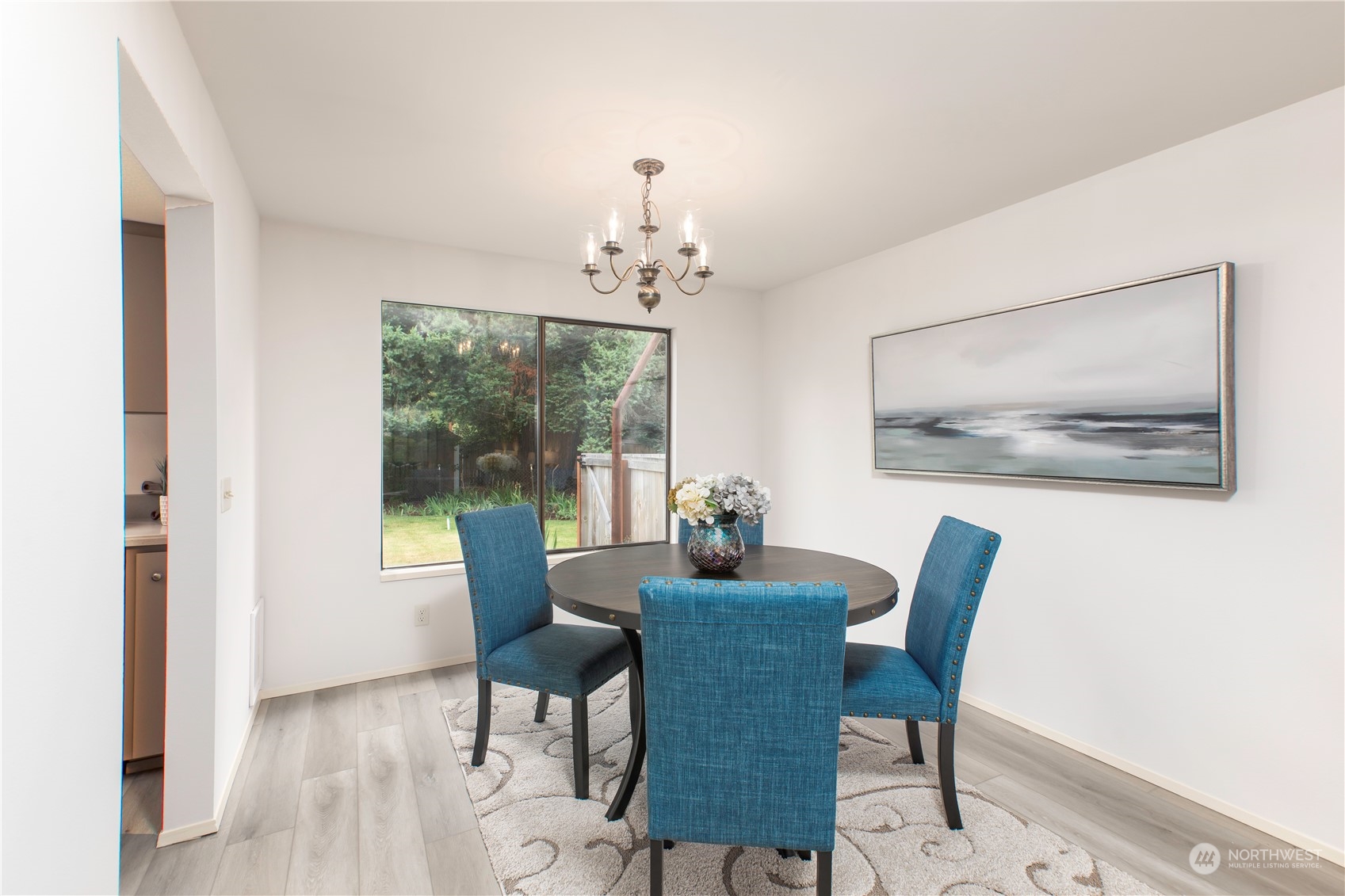 9503 127th Place Southeast Renton, WA 98056 - Photo 7 of 32 a dining room with furniture a large window and a chandelier
