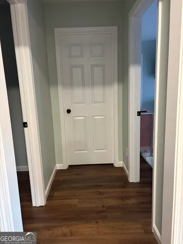 an empty room with wooden floor and closet
