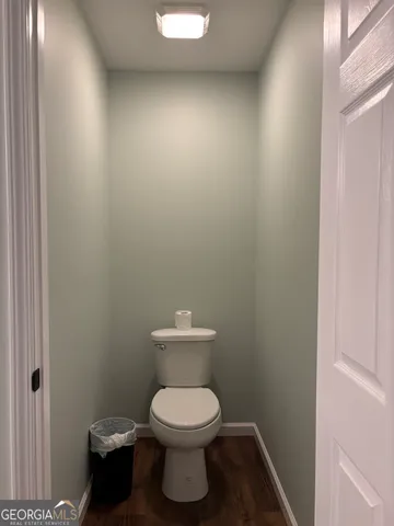 a white toilet sitting next to a white sink
