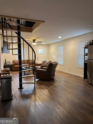a living room with furniture and wooden floor