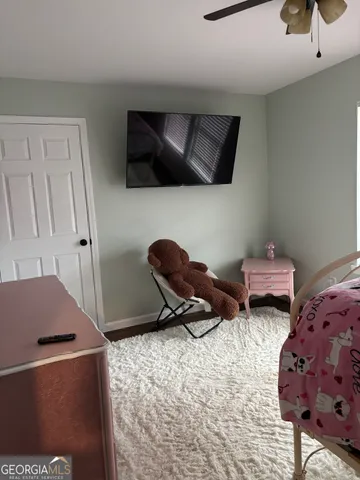 a bedroom with bed and window