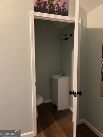 a view of a hallway with closet and wooden floor