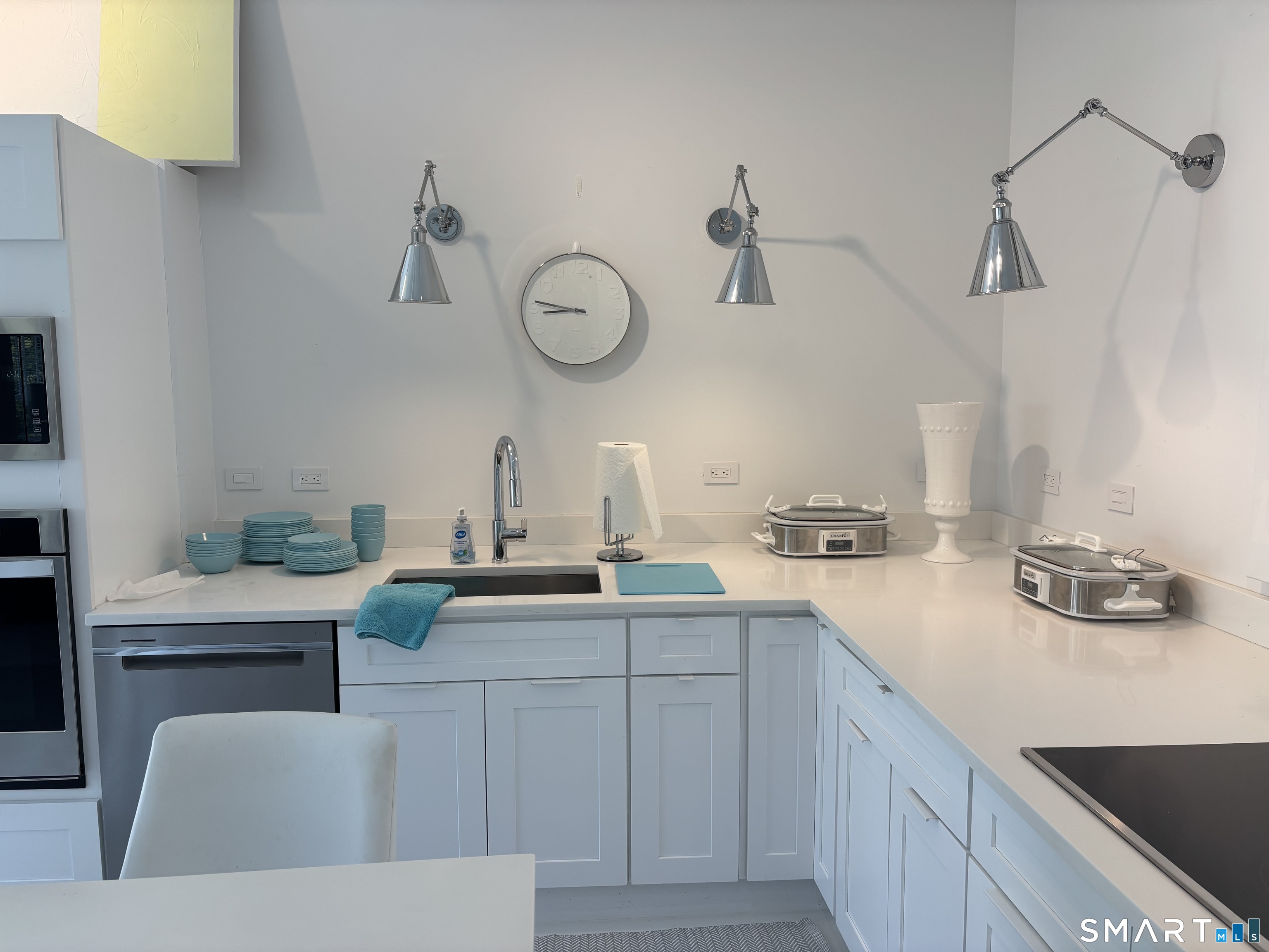 4 A Stoneboat Road Westport, CT 06880 - Photo 13 of 24 a kitchen with a sink dishwasher and white cabinets with wooden floor