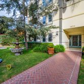 a view of a house with garden and a bench