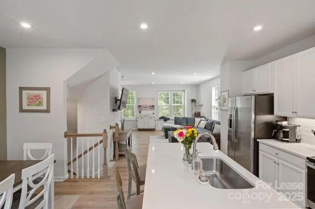 a kitchen with stainless steel appliances granite countertop a refrigerator and a sink
