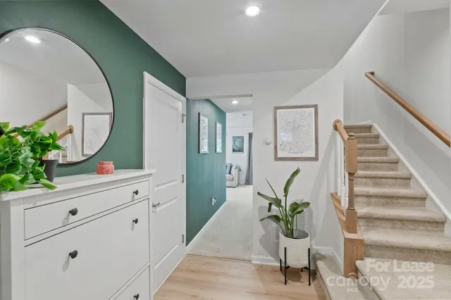 a living room with furniture and a mirror