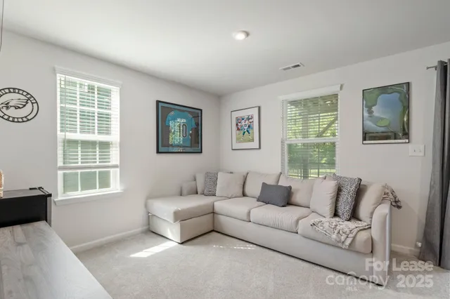 a living room with furniture and windows