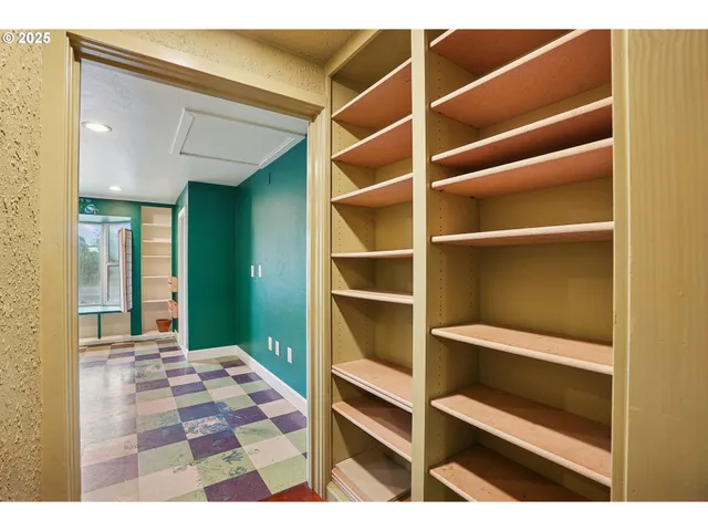 a view of an empty room with empty shelves