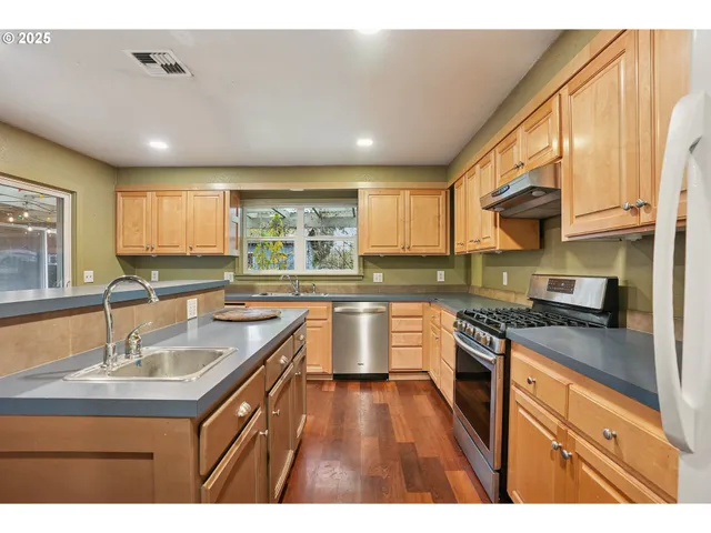 a kitchen with a sink stove and cabinets