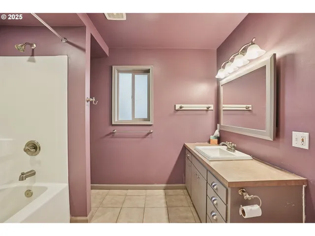 a bathroom with a sink a mirror and a bathtub