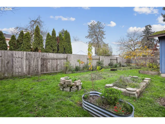 a backyard of a house with table and chairs