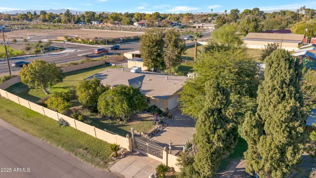 an aerial view of a residential houses with outdoor space and river view