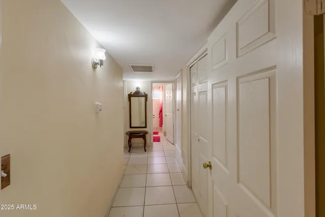 a bedroom with a bed and a flat tv screen on the dresser