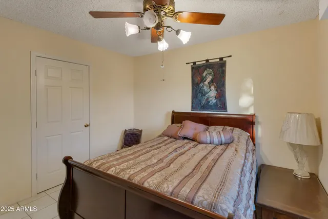 a bed room with a bed and a chandelier